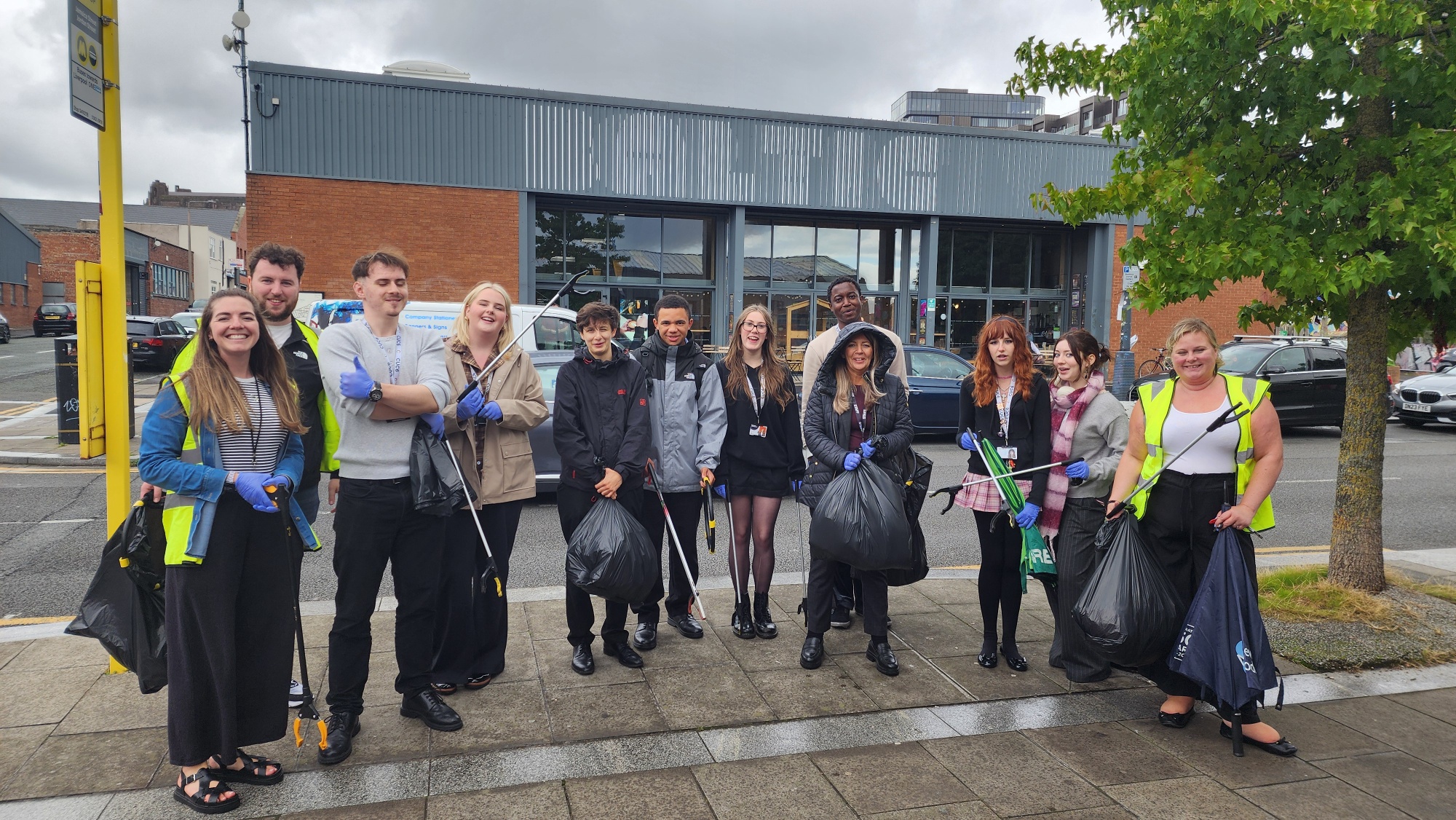 Group of sixth from students on a litter picking activity, alongside Head of Sixth Form and staff member from Baltic Creative.