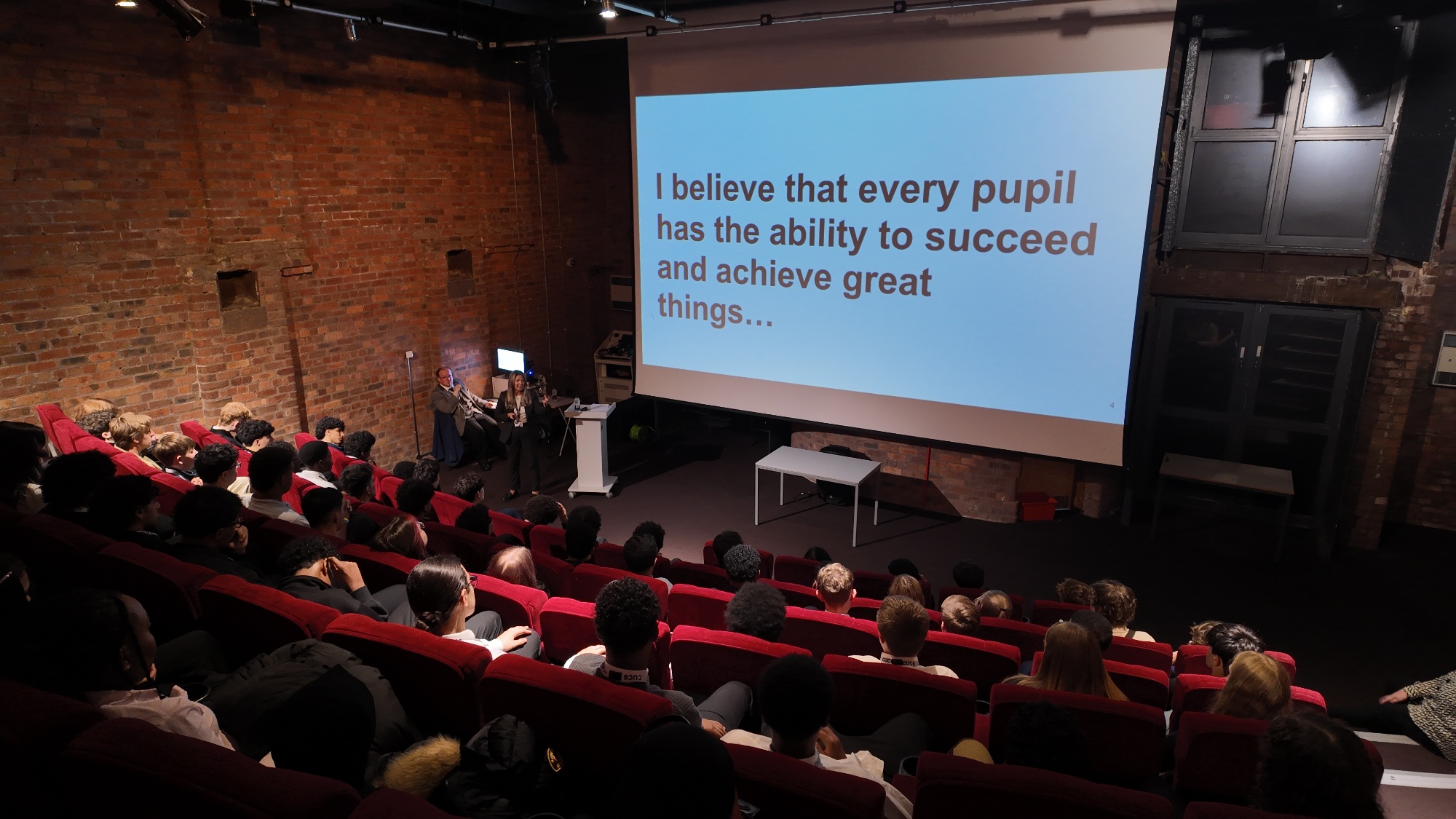 Image of sixth form students sat in front of a presentation slide delivered by sixth form staff, this slide says 