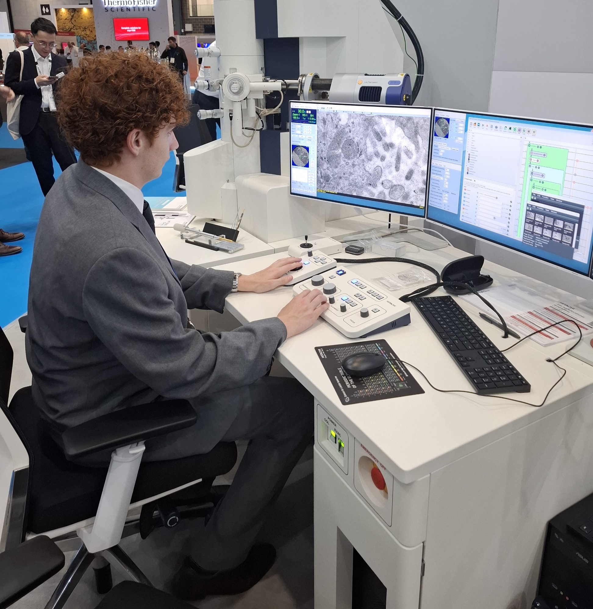 Image of sixth form student sat in front of a computer at the International Microscopy Congress
