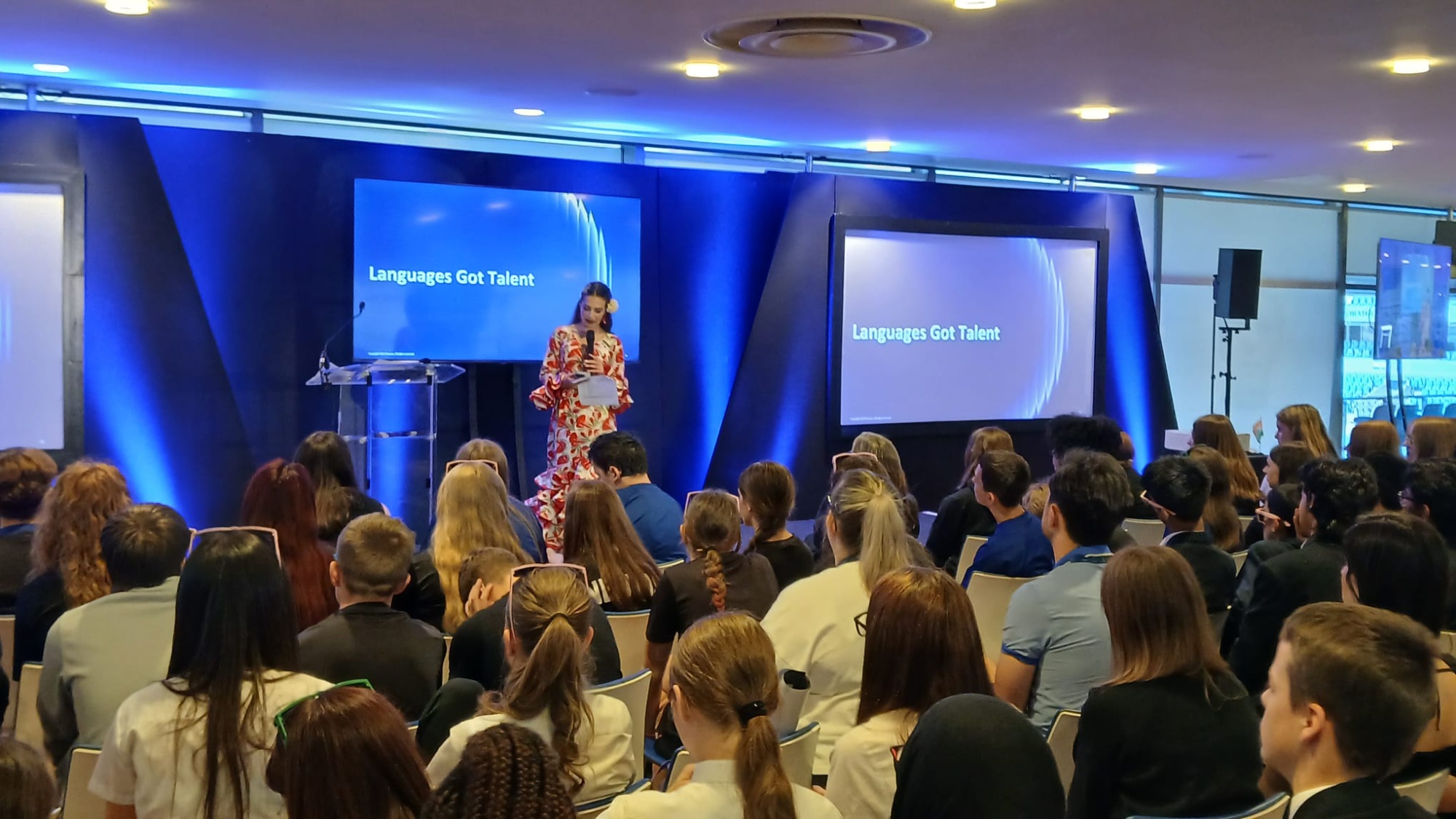 Image of group of people sat down at the languages conference in front of a guest speaker