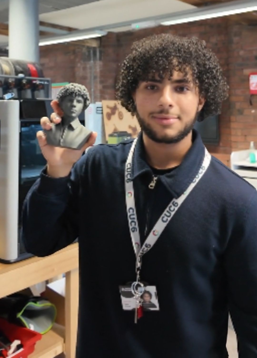 Engineering Sixth Form student holding up 3D print of his own face